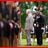 King Charles III speaks to a member of Royal Company of Archers, The King's Bodyguard Scotland, at the Ceremony of the Keys in the gardens of the Palace of Holyroodhouse in Edinburgh. Picture: Jane Barlow/PA Wire