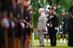 King Charles III speaks to a member of Royal Company of Archers, The King's Bodyguard Scotland, at the Ceremony of the Keys in the gardens of the Palace of Holyroodhouse in Edinburgh. Picture: Jane Barlow/PA Wire