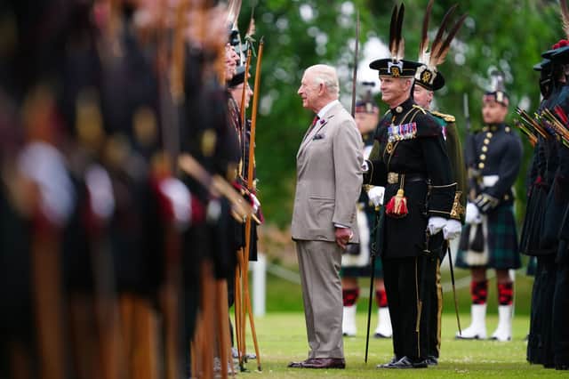 King Charles III speaks to a member of Royal Company of Archers, The King's Bodyguard Scotland, at the Ceremony of the Keys in the gardens of the Palace of Holyroodhouse in Edinburgh. Picture: Jane Barlow/PA Wire