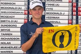 Blairgowrie amateur Connor Graham proudly shows off his flag after qualifying for The 153rd Open at Royal Portrush