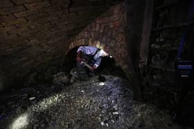 A technician shovels the fat as he works in a Victorian sewer. Picture: Adrian Dennis/AFP via Getty Images
