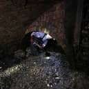 A technician shovels the fat as he works in a Victorian sewer. Picture: Adrian Dennis/AFP via Getty Images