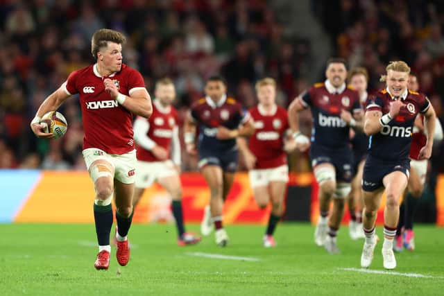 Huw Jones of the British & Irish Lions breaks away to score against the Queensland Reds.