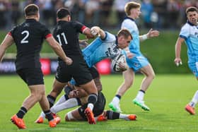 Scotland's Stafford McDowall (R) and Maori All Black's Daniel Rona (L) in action.