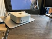 My Apple Mac mini M4 set up neatly under the monitor on my home office desk.
