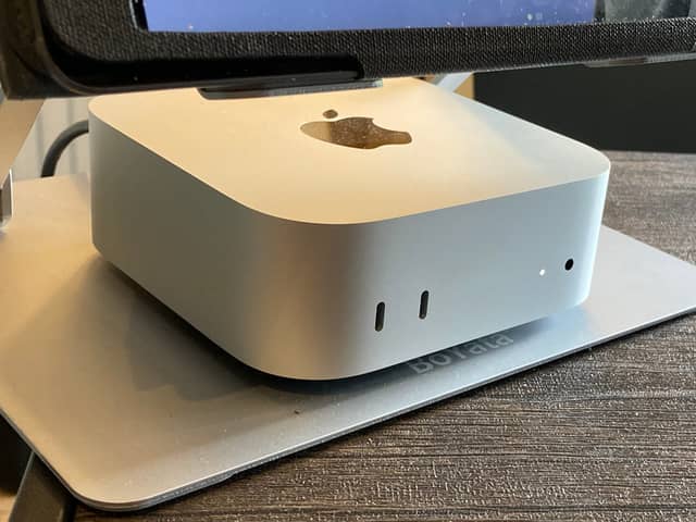 My Apple Mac mini M4 set up neatly under the monitor on my home office desk.
