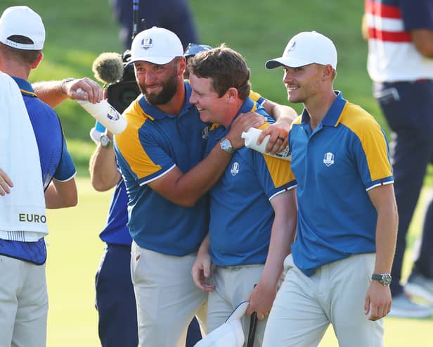 Bob MacIntyre is congratulated by Jon Rahm after winning his singles in the 2023 Ryder Cup in Rome