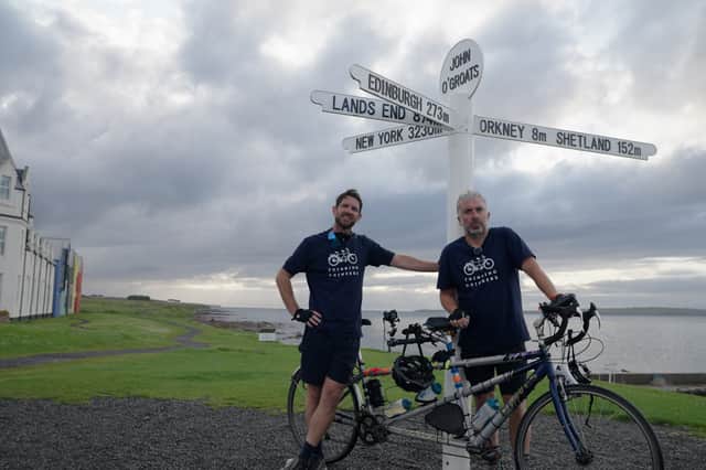 Ben McFarland and Tom Sandham, together known as the 'Thinking Drinkers' at John O'Groats on their Great British Pub Ride.
