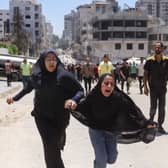 Two girls react after an Israeli strike in Gaza on Tuesday