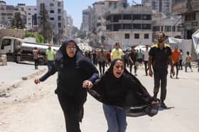 Two girls react after an Israeli strike in Gaza on Tuesday