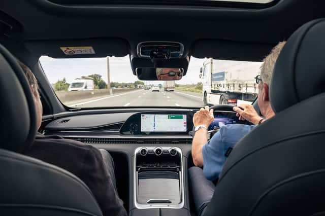 The interior of the Omoda 9, while Jim hogs the middle lane