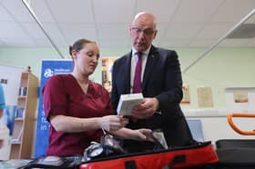 First Minister John Swinney medical staff Louise Kirkby, during a visit to Falkirk Community Hospital in Falkirk, to announce £85 million in additional funding to support initiatives that improve the flow of patients through the health service and support the expansion of the Hospital at Home service