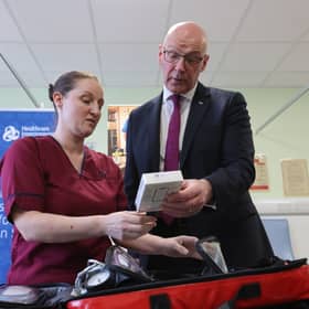 First Minister John Swinney medical staff Louise Kirkby, during a visit to Falkirk Community Hospital in Falkirk, to announce £85 million in additional funding to support initiatives that improve the flow of patients through the health service and support the expansion of the Hospital at Home service