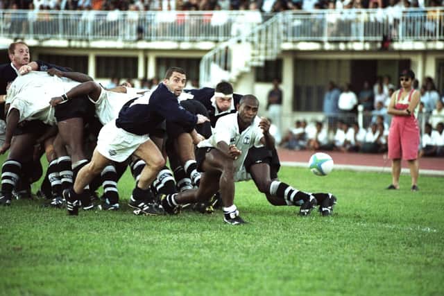Samisoni Rabaka of Fiji passes the ball out as Bryan Redpath of Scotland looks on during the match in Suva in 1998. Fiji won 51-26.