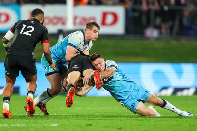 Scotland's Fergus Burke, right, shows his physical prowess as he makes a tackle during the win over New Zealand Maori in Whangarei.