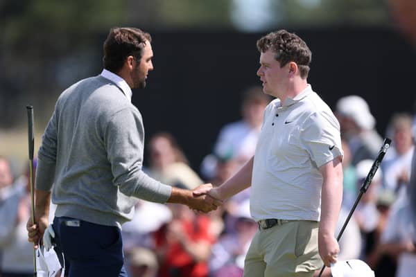 Scottie Scheffler and Bob  MacIntyre shake hands at the end of the opening round in the Genesis Scottish Open at The Renaissance Club 