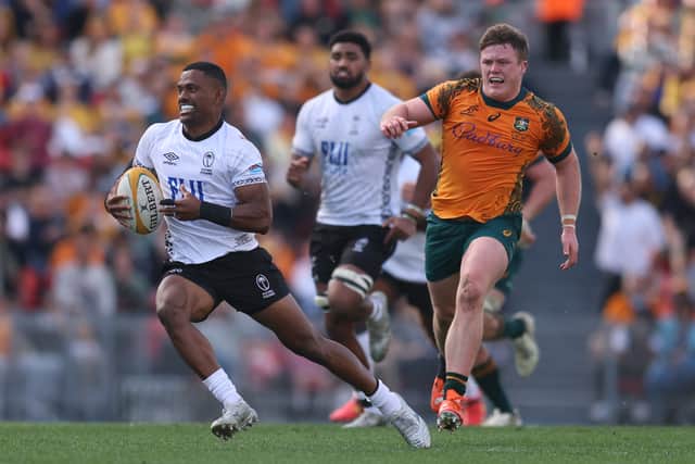Jiuta Wainiqolo of Fiji leaves the Australia defender in his wake.