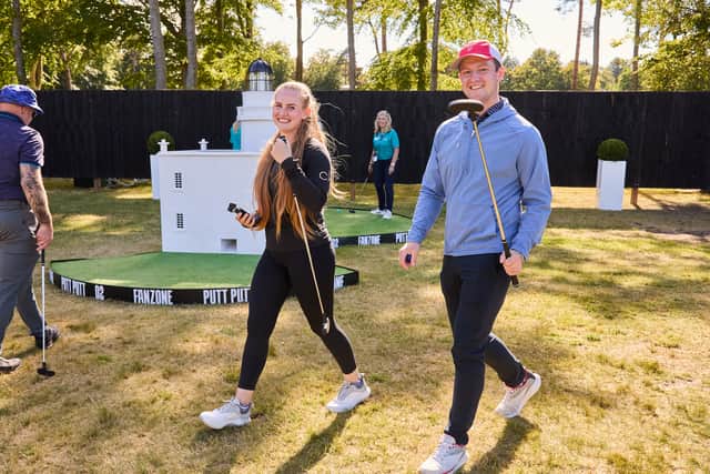 Spectators enjoy the Mini Golf facility in the Genesis Scottish Open Fan Zone