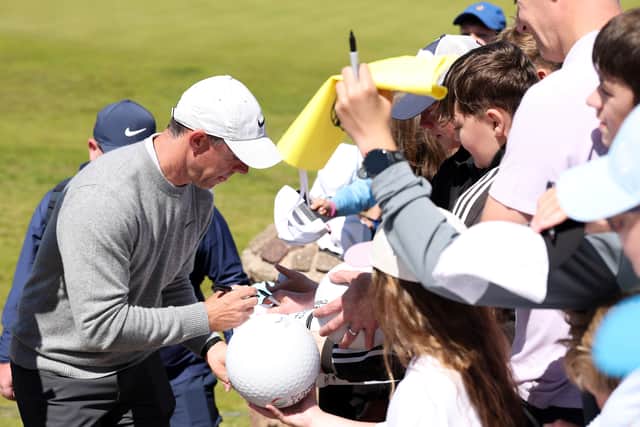 Grand slam winner Rory McIlroy signs autographs for fans during the pro-am prior to the Genesis Scottish Open at The Renaissance Club
