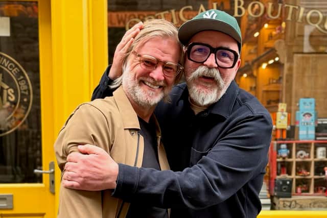 Steven Pressley pictured with Richard Cook, the owner of Land O' Specs, after receiving his new glasses.