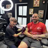 Lorraine Kelly 'tattooing' Island Games shot put competitor and tattoo artist Calum Elder