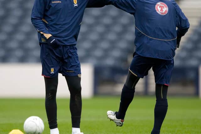 Steven Pressley (left) stretches off with Scotland captain Barry Ferguson in 2007.