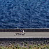 People walk their dogs beside the Mugdock reservoir near Milngavie (Picture: Jeff J Mitchell)