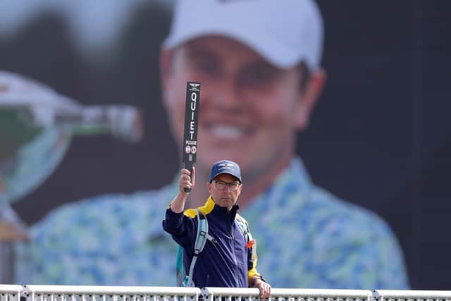 A marshal holds a sign at The Renaissance Club