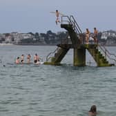 What could go wrong? People jump into the sea from a diving platform near Saint-Malo in France (Picture: Damien Meyer)