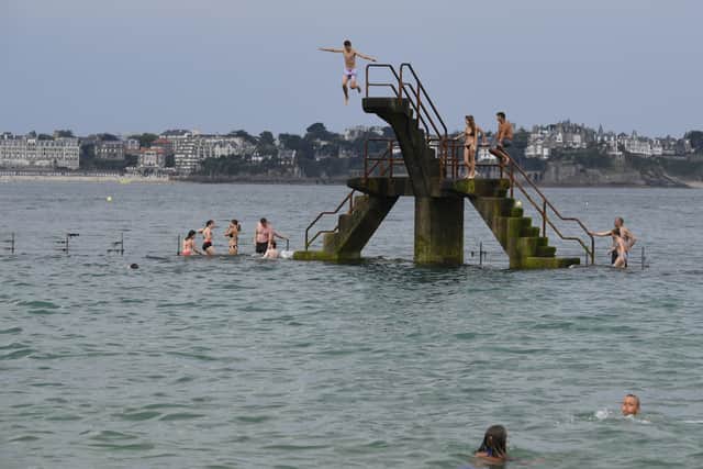 What could go wrong? People jump into the sea from a diving platform near Saint-Malo in France (Picture: Damien Meyer)
