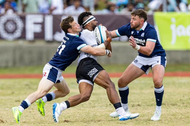George Horne and Ollie Smith combine to try stop a Fijian attack in Suva.