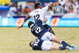 Josua Tuisova manages to offload despite the attentions of Tom Jordan and Fergus Burke.