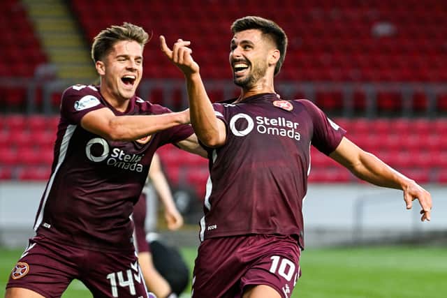 Hearts' Claudio Braga (R) celebrates scoring to make it 4-0 with teammate Cammy Devlin.