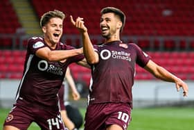 Hearts' Claudio Braga (R) celebrates scoring to make it 4-0 with teammate Cammy Devlin.