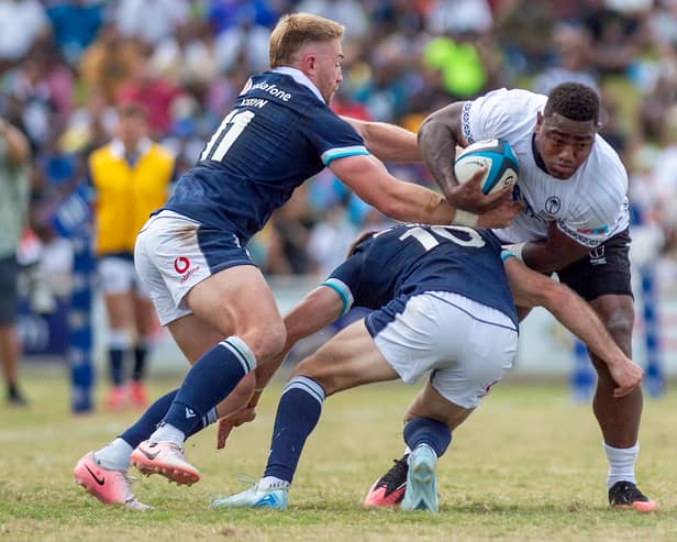 Scotland's Kyle Steyn, left, and Fergus Burke try to stop Fiji's Josua Tuisova during the 29-14 defeat in Suva.