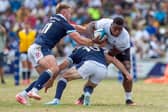 Scotland's Kyle Steyn, left, and Fergus Burke try to stop Fiji's Josua Tuisova during the 29-14 defeat in Suva.