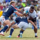 Scotland's Kyle Steyn, left, and Fergus Burke try to stop Fiji's Josua Tuisova during the 29-14 defeat in Suva.