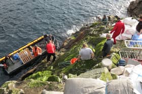A photo of guga hunters landing on the island during a hunt in previous years 