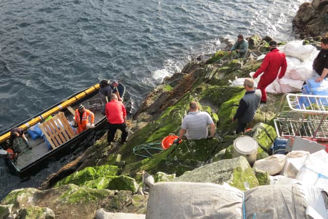 A photo of guga hunters landing on the island during a hunt in previous years