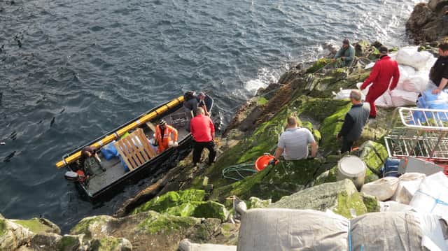 A photo of guga hunters landing on the island during a hunt in previous years