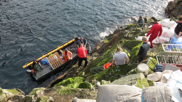 A photo of guga hunters landing on the island during a hunt in previous years
