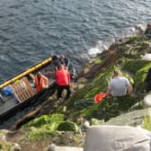 A photo of guga hunters landing on the island during a hunt in previous years 