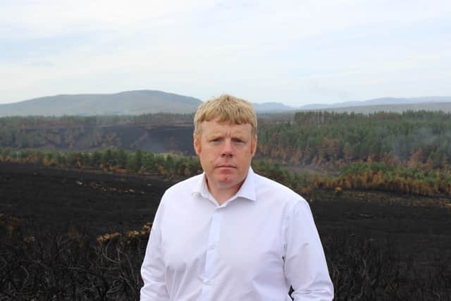 MSP Tim Eagle at one of the sites where flames ripped through the countryside three weeks ago