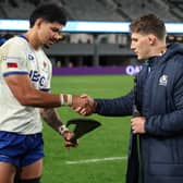 Captains Theo McFarland of Samoa and Rory Darge of Scotland exchange gifts following the Test match between the sides at Eden Park in Auckland.
