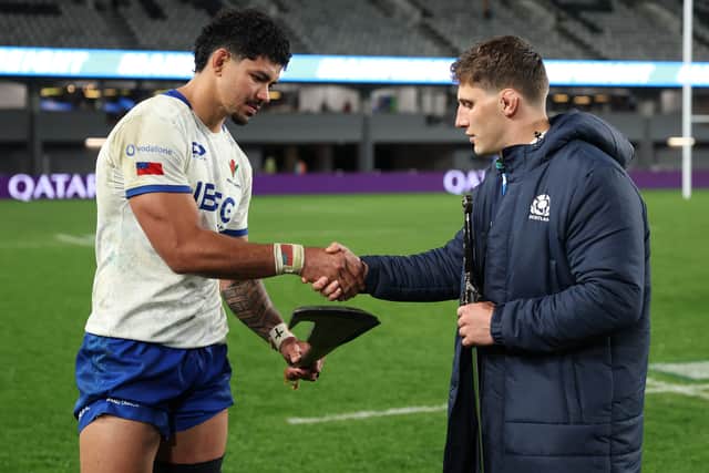 Captains Theo McFarland of Samoa and Rory Darge of Scotland exchange gifts following the Test match between the sides at Eden Park in Auckland.