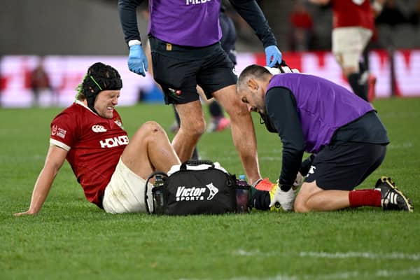 Pain is etched on the face of Darcy Graham as he receives treatment for an injury during the British and Irish Lions' win over the First Nations & Pasifika XV in Melbourne.