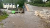 Floodwater gushes onto track at Achanalt station.