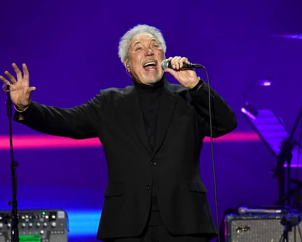Sir Tom Jones performs on stage.