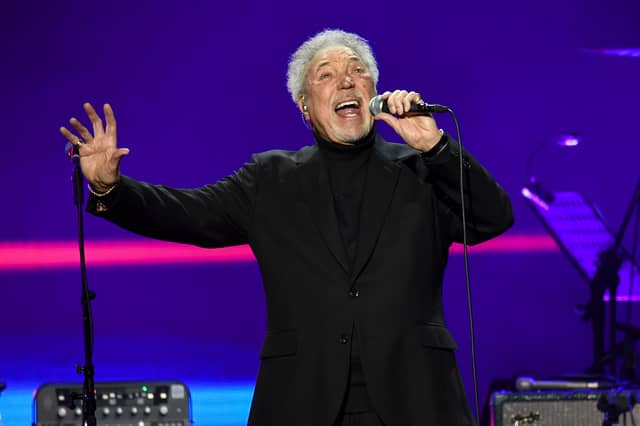 Sir Tom Jones performs on stage.