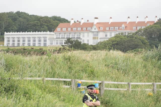 A bit of side-eye from a police officer standing at Trump's Turnberry golf course